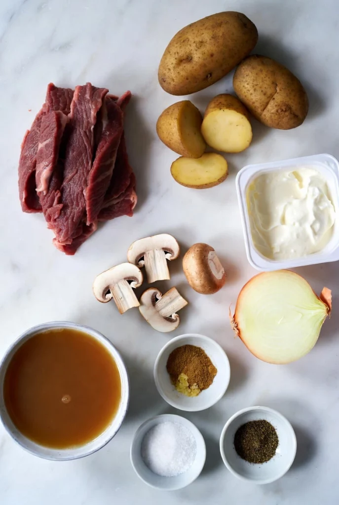 Ingredients for Potato Beef Stroganoff including beef, potatoes, mushrooms, onion, and sour cream