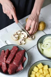 Slicing fresh mushrooms for potato beef stroganoff recipe