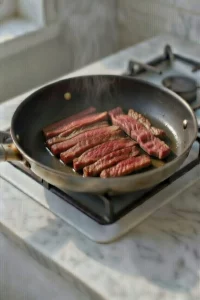 Ground beef browning in a skillet for potato beef stroganoff