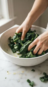 Kale being massaged with olive oil and lemon juice