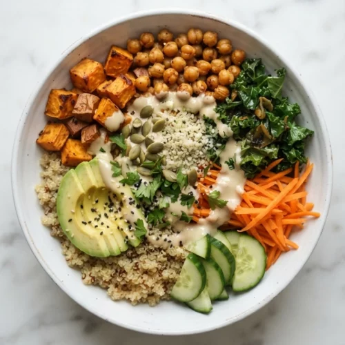 Overhead view of quinoa buddha bowl recipe in a white dish