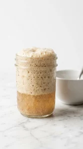 Active dry yeast foaming in warm water before mixing into dough